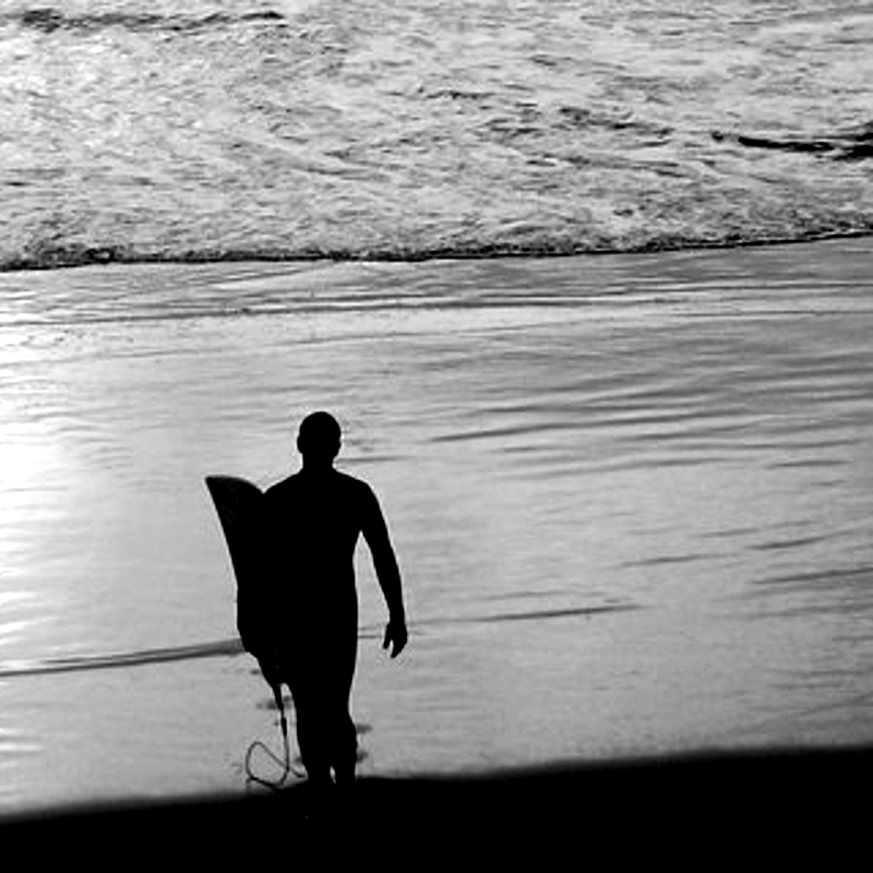 surfer walking into surf